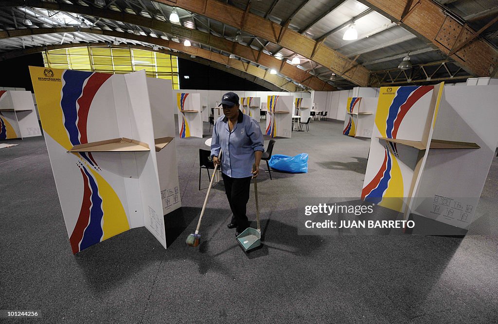 A worker cleans a polling center in Bogo