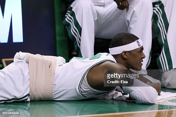 Rajon Rondo of the Boston Celtics lies on the court as he receives treatment on his back after he took a hard fall in the first half against the...