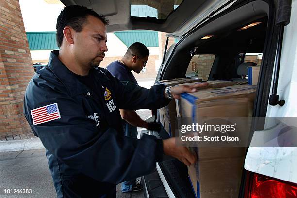 Special agents from Immigration and Customs Enforcement search a vehicle heading into Mexico at the Hidalgo border crossing on May 28, 2010 in...