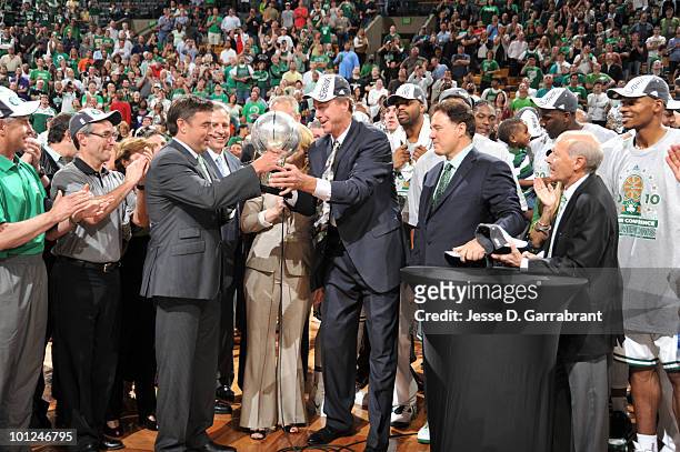 Dave Cowens presents owner Wyc Grousbeck of the Boston Celtics with the Eastern Conference trophy against the Orlando Magic in Game Six of the...