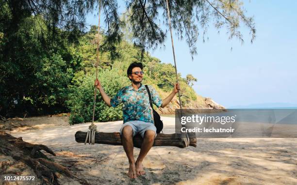 young man relaxing on the beach of the koh lanta island, thailand - thailand tourist stock pictures, royalty-free photos & images