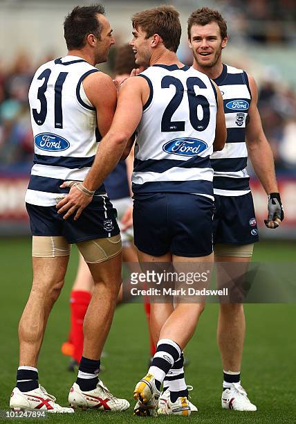 James Podsiadly, Cameron Mooney and Tom Hawkins of the Cats celebrate a goal during the round 10 AFL match between the Geelong Cats and the Melbourne...