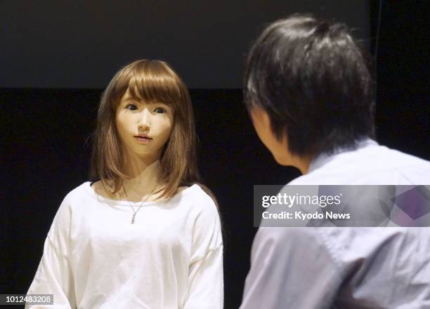 An android developed by Osaka University professor Hiroshi Ishiguro and his team, talks to a man during a demonstration in Tokyo on July 31, 2018....