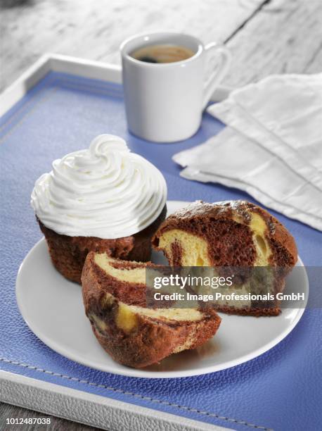 chocolate and vanilla swirl cupcake with buttercream frosting on leather tray with espresso coffee - cupcake stock pictures, royalty-free photos & images