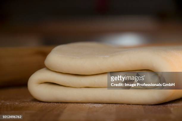 folded yeast dough on a wooden surface - puff pastry stock pictures, royalty-free photos & images
