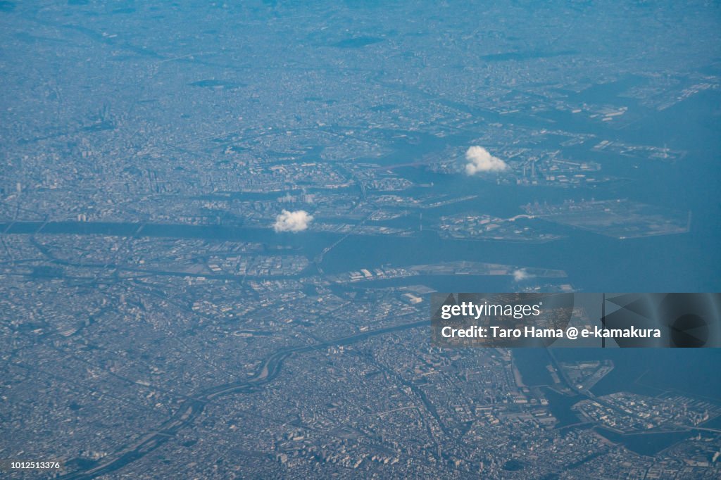 Osaka Bay, Osaka and Toyonaka cities in Osaka prefecture in Japan sunset time aerial view from airplane