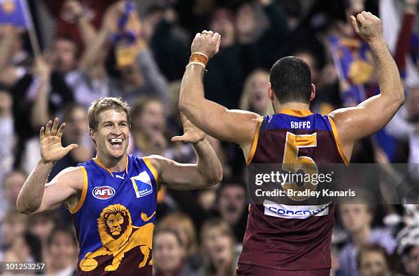 Luke Power and Brendan Fevola of the Lions celebrate after a goal during the round 10 AFL match between the Brisbane Lions and the Collingwood...