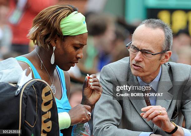 Serena Williams takes a pill next to a doctor during her women's third round match against Russia's Anastasia Pavlyuchenko in the French Open tennis...