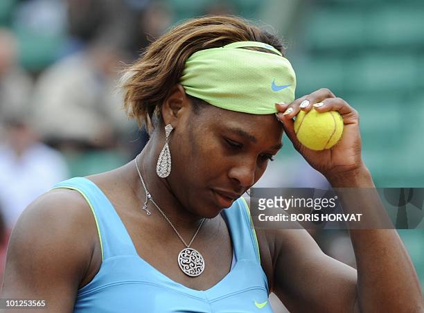Serena Williams looks down during her women's third round match against Russia's Anastasia Pavlyuchenko in the French Open tennis championship at the...