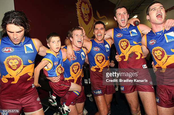 Luke Power celebrates victory with his team mates after the round 10 AFL match between the Brisbane Lions and the Collingwood Magpies at The Gabba on...