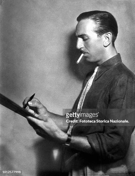 Walt Disney , animator, entrepreneur, designer, filmmaker, voice actor and American film producer, portrayed in profile while drawing on a sketch...