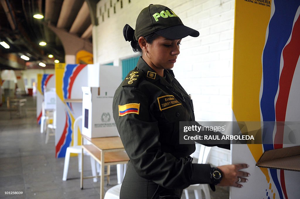 A Colombian police officer inspects elec