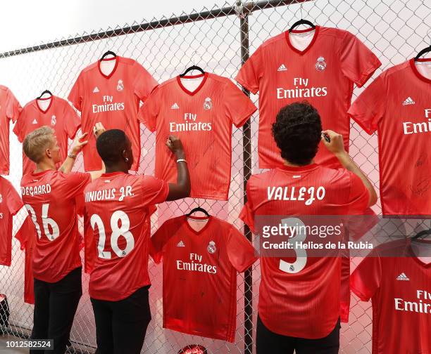 Martin Odegaard, Vinicius Jr and Jesus Vallejo of Real Madrid sign shirts during the new third kit launch on August 6, 2018 in New York, NY.