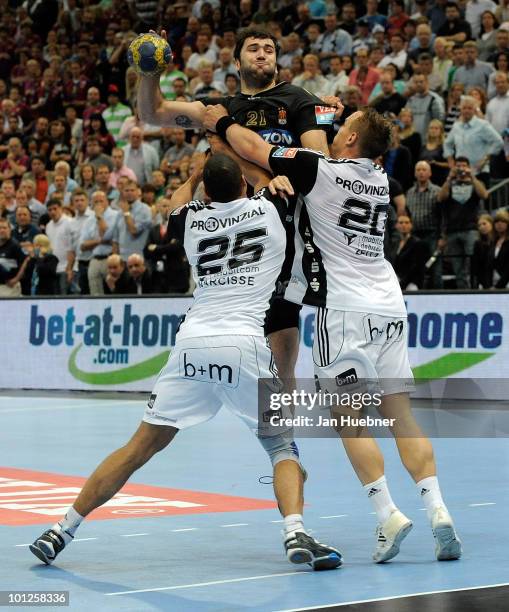 Daniel Narcisse and Christian Zeitz of THW Kiel try to block Joan Canellas of Ciudad Real during the handball semi final match between Ciudad Real...