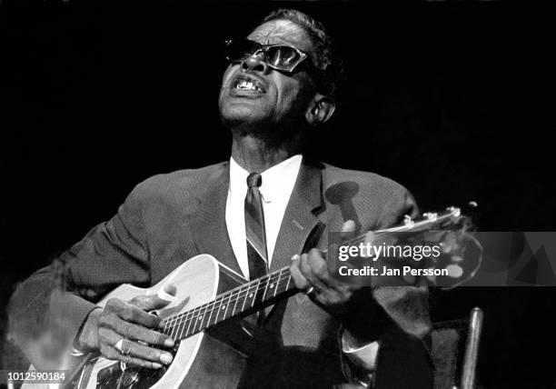 American blues singer and guitarist Lightnin' Hopkins performing in Copenhagen, Denmark, 1964.