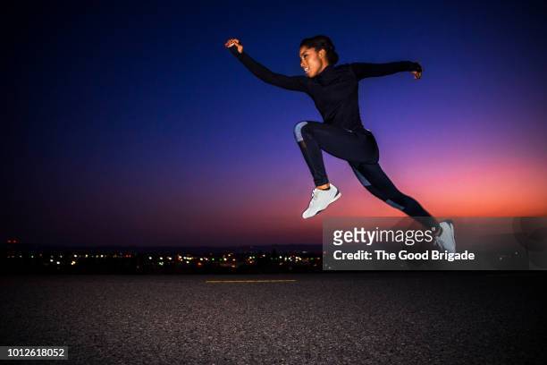 athletic female running at night - day for night 2017 fotografías e imágenes de stock