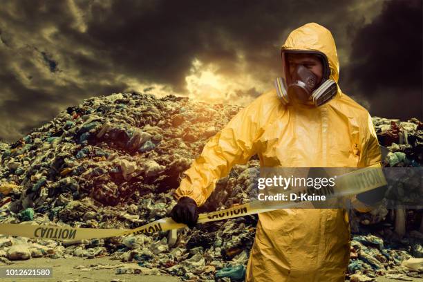 garbage dump - protective suit stock pictures, royalty-free photos & images