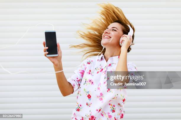 young girl dancing to the music - hair toss stock pictures, royalty-free photos & images