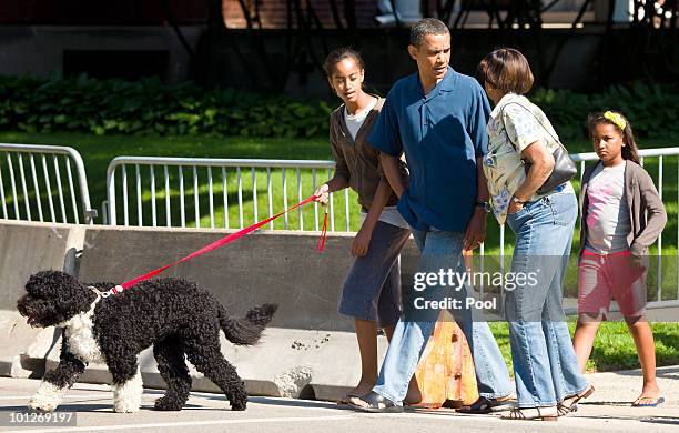 President Barack Obama takes a walk down the street from his home accompanied by his mother-in-law Marian Robinson, daughters Malia Obama and Sasha...