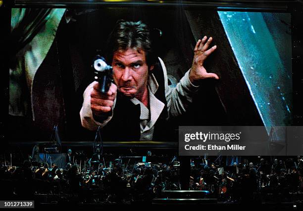 Actor Harrison Ford's Han Solo character from "Star Wars Episode VI: Return of the Jedi" is shown on screen while musicians perform during "Star...