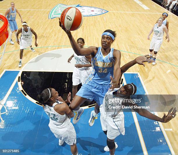 Sylvia Fowles of the Chicago Sky lays up a shot against Hamchetou Maiga-Ba and Monica Wright of the Minnesota Lynx during the game on May 29, 2010 at...