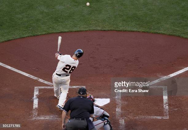 Buster Posey of the San Francisco Giants hits a single in his first game of the season at bat that scored Freddy Sanchez to give the Giants a 2-0...