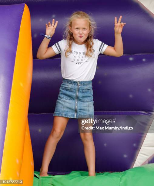 Savannah Phillips plays on an inflatable bouncy slide as she attends day 1 of The Festival of British Eventing at Gatcombe Park on August 3, 2018 in...