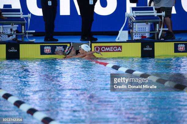 National Championships: Regan Smith victorious, hugging Kathleen Baker after tying for first place in the Women's 200M backstroke final at William...