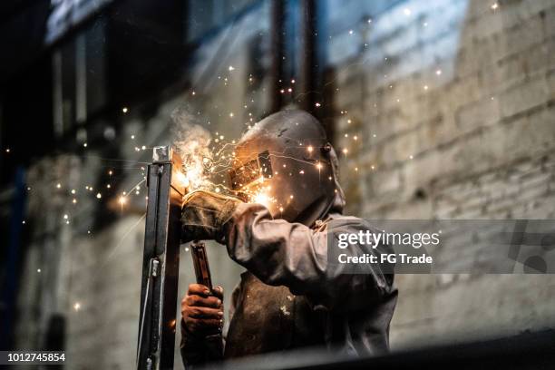 industrial worker welding steel - man wearing protective face mask stock pictures, royalty-free photos & images