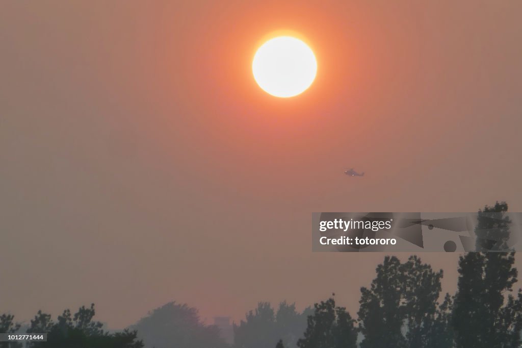 Sunset under smoky sky due to BC forest wildfire, in Vancouver BC Canada.
