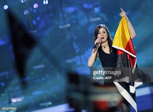 Germany's Lena Meyer-Landrut sings with her national flag after winning the Eurovision Song Contest 2010 final at the Telenor Arena in Baerum, near...