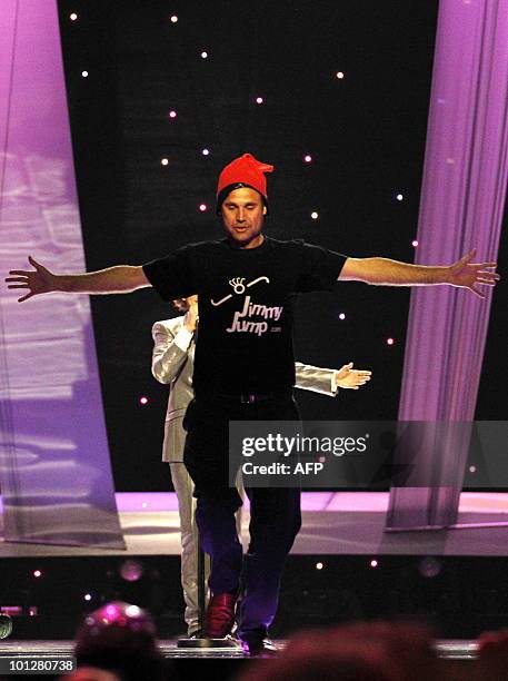 Streaker wearing a red cap and a t-shirt reading "Jimmy Jump", appears on stage as Spain's Daniel Diges performs his song "Algo Pequeñito " during...