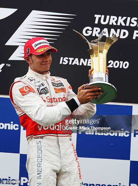 Lewis Hamilton of Great Britain and McLaren Mercedes celebrates on the podium after winning the Turkish Formula One Grand Prix at Istanbul Park on...