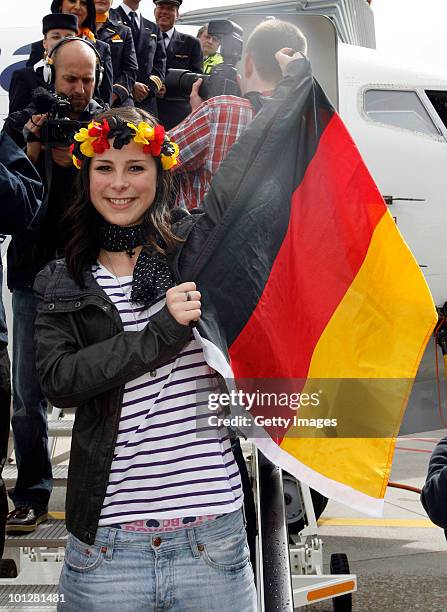 Lena Meyer-Landrut, winner of the Eurovision Song Contest 2010, jubilates during her arrival at Hanover airport on May 30, 2010 in Hanover, Germany....