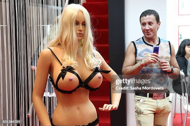 Visitor looks at a mannequin on an exhibition stand at The International Specialized X-SHOW Exhibition for Adults 2010 on May 2010 in Moscow, Russia....
