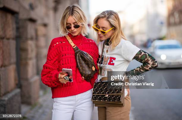 Lisa Hahnbueck wearing red Isabel Marant knit pullover, Louis Vuitton Bum bag, Yeezy 500 Adidas sneaker, white Redone Levis jeans, Ray Ban sunglasses...