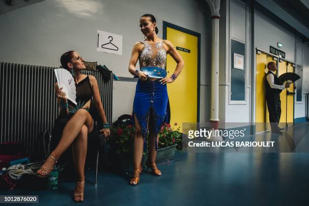 Participants take a break between rounds of the dancing contest in the 10th edition of the international Gay Games at the Gymnase Japy in Paris, on...