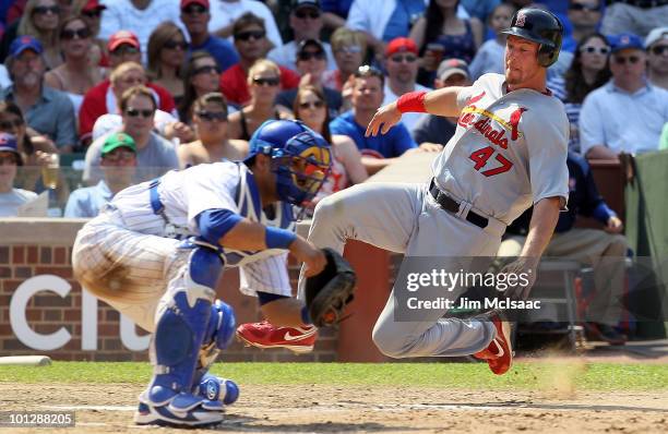 Ryan Ludwick of the St. Louis Cardinals scores a seventh inning run past Geovany Soto of the Chicago Cubs on May 30, 2010 at Wrigley Field in...