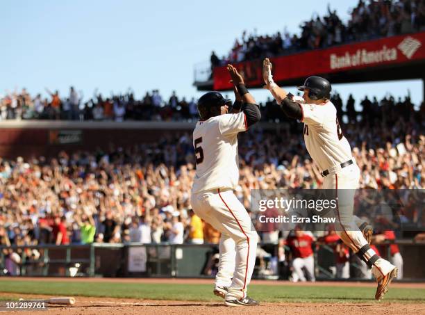 Juan Uribe is congratulated by Freddy Sanchez after Uribe scored the winning run on a single by Andres Torres of the San Francisco Giants in the 10th...