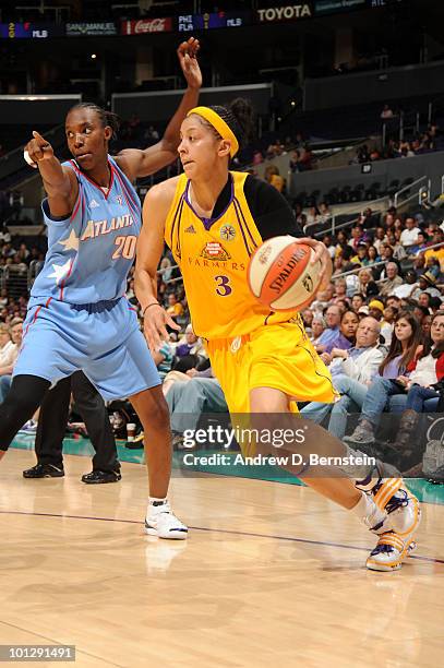 Candace Parker of the Los Angeles Sparks drives to the basket against Sancho Lyttle of the Atlanta Dream during the WNBA game at Staples Center on...