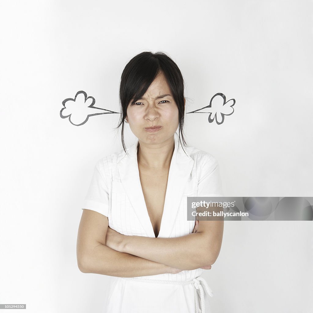 Young asian woman with steam coming out her ears.