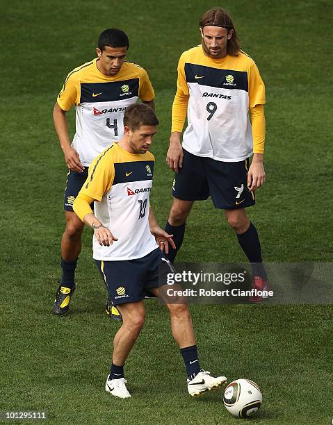 Harry Kewell of Australia controls the ball as Tim Cahill and Josh Kennedy look on during an Australian Socceroos training session at St Stithians...