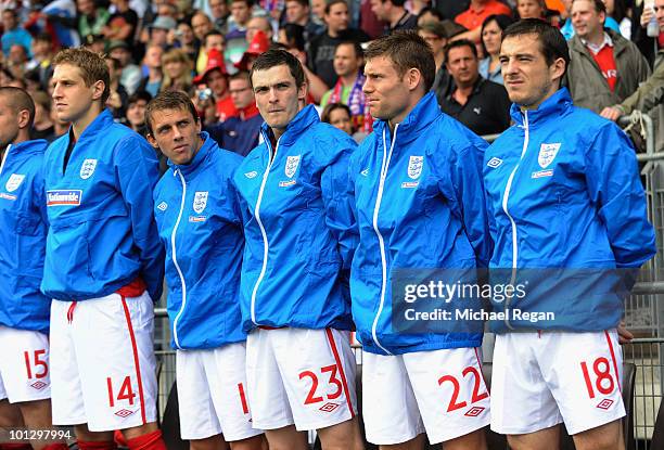 Michael Dawson, Stephen Warnock, Adam Johnson, James Milner and Leighton Baines of England look on from the bench during the International Friendly...