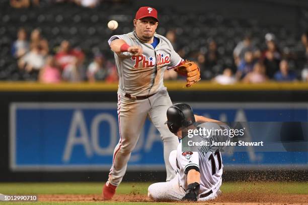 Asdrubal Cabrera of the Philadelphia Phillies turns the double play over A.J. Pollock of the Arizona Diamondbacks at Chase Field on August 7, 2018 in...