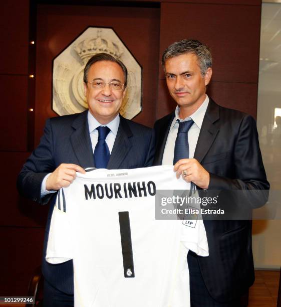 Jose Mourinho poses next to President of Real Madrid Florentino Perez after signing his contract to become the new head coach of Real Madrid coach at...