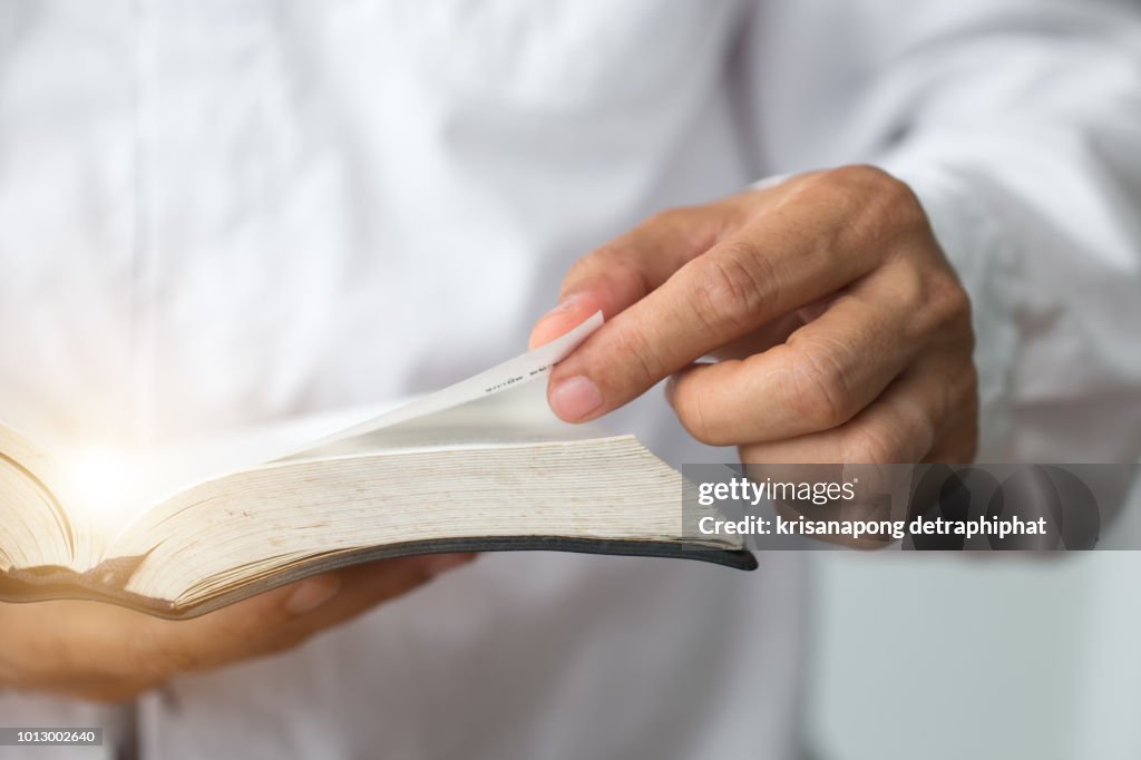 A man reading the Holy Bible.A man reading a book.