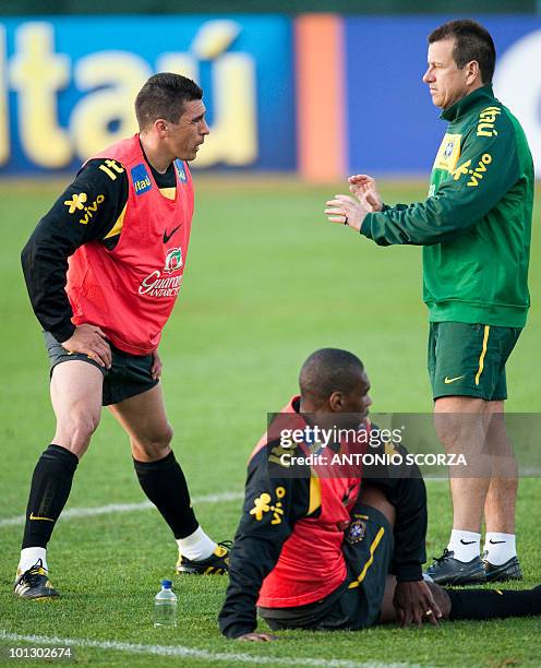 Brazil's coach Dunga gives instructions to defenders Lucio and Juan on May 31, 2010 during the practice at Randburg High School in Johannesburg....