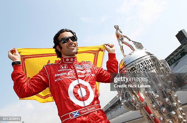 Dario Franchitti of Scotland, driver of the Target Chip Ganassi Racing Dallara Honda, poses with the Borg Warner trophy on the yard of brick during...