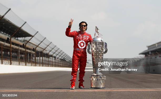 Dario Franchitti of Scotland, driver of the Target Chip Ganassi Racing Dallara Honda, poses with Borg Warner Trophy on the yard of bricks during the...