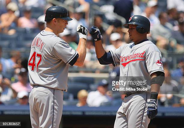 Jhonny Peralta of the Cleveland Indians is greeted by Shelley Duncan after hitting a solos homerun in the second-inning against the New York Yankees...